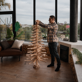 Handmade wooden Christmas tree with rotating branches and natural wood design