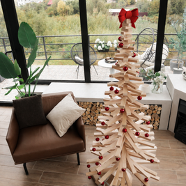 Handmade wooden Christmas tree with rotating branches and natural wood design