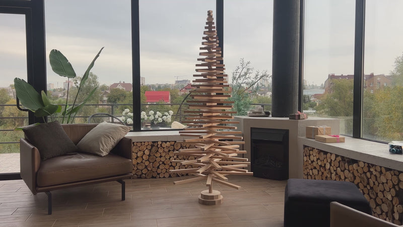 Handmade wooden Christmas tree with rotating branches and natural wood design