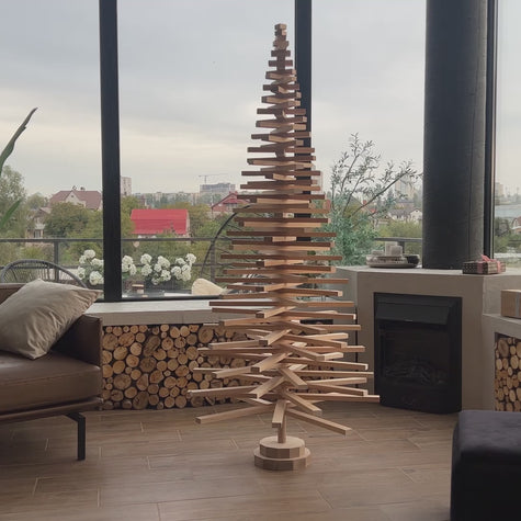 Handmade wooden Christmas tree with rotating branches and natural wood design