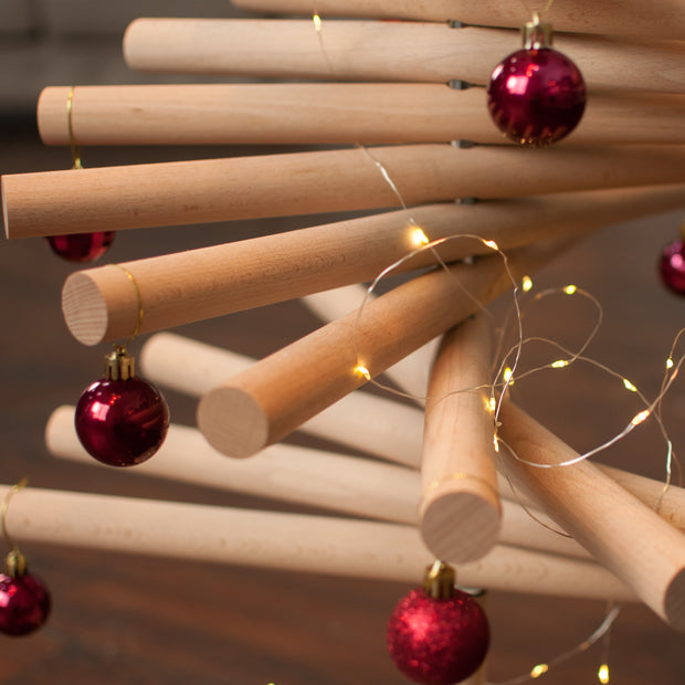 Handmade wooden Christmas tree with rotating branches and natural wood design