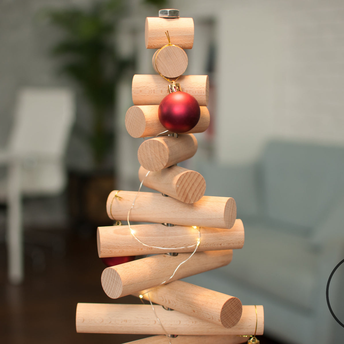 Handmade wooden Christmas tree with rotating branches and natural wood design