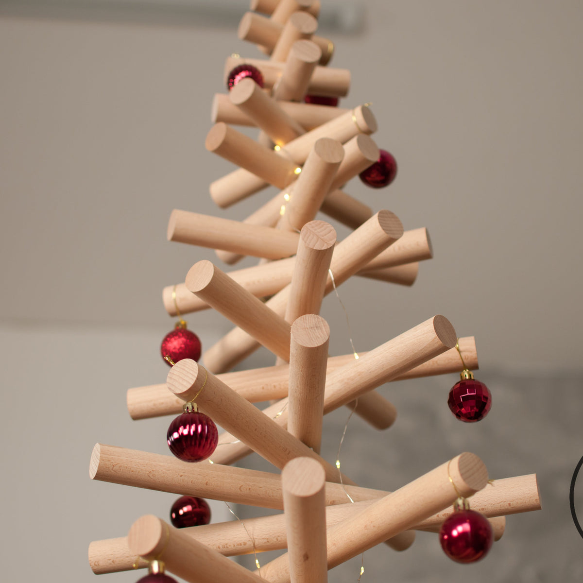 Handmade wooden Christmas tree with rotating branches and natural wood design