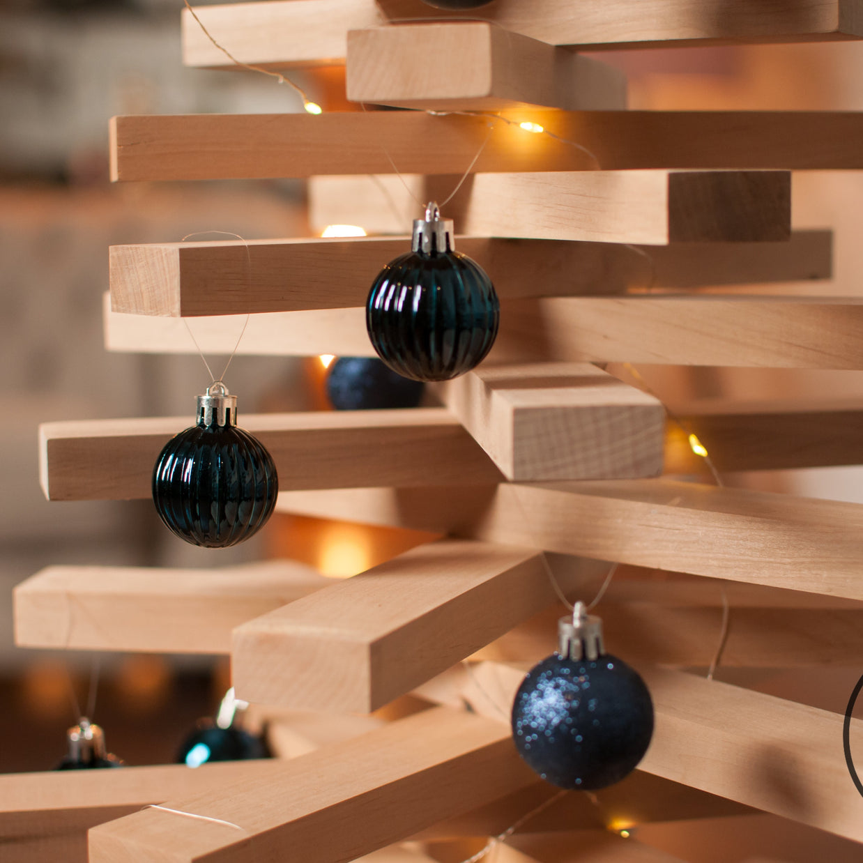 Handmade wooden Christmas tree with rotating branches in modern Scandinavian living room