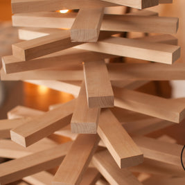 Handmade wooden Christmas tree with rotating branches in modern Scandinavian living room
