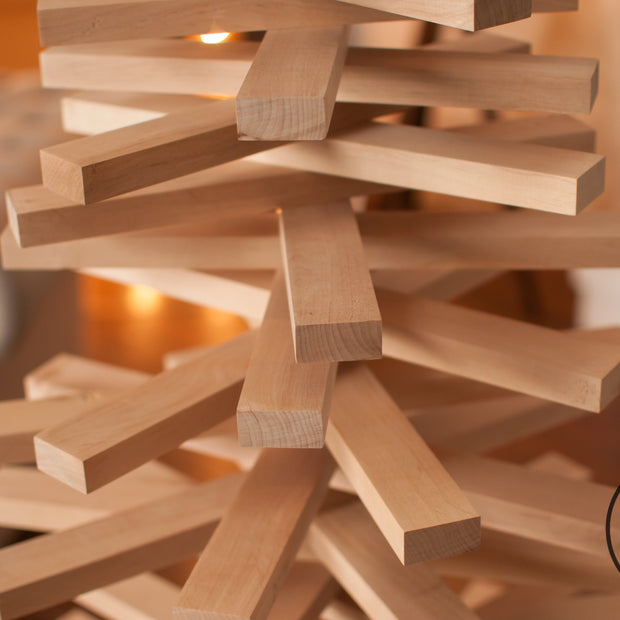 Handmade wooden Christmas tree with rotating branches in modern Scandinavian living room