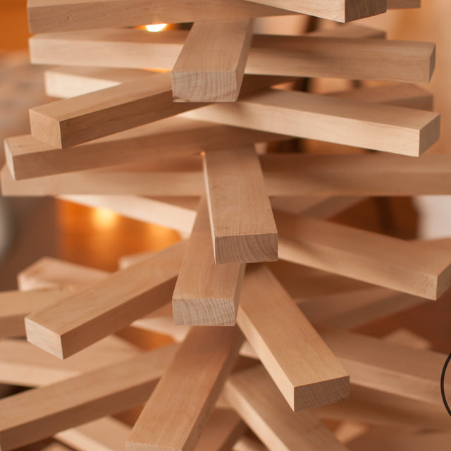 Handmade wooden Christmas tree with rotating branches in modern Scandinavian living room