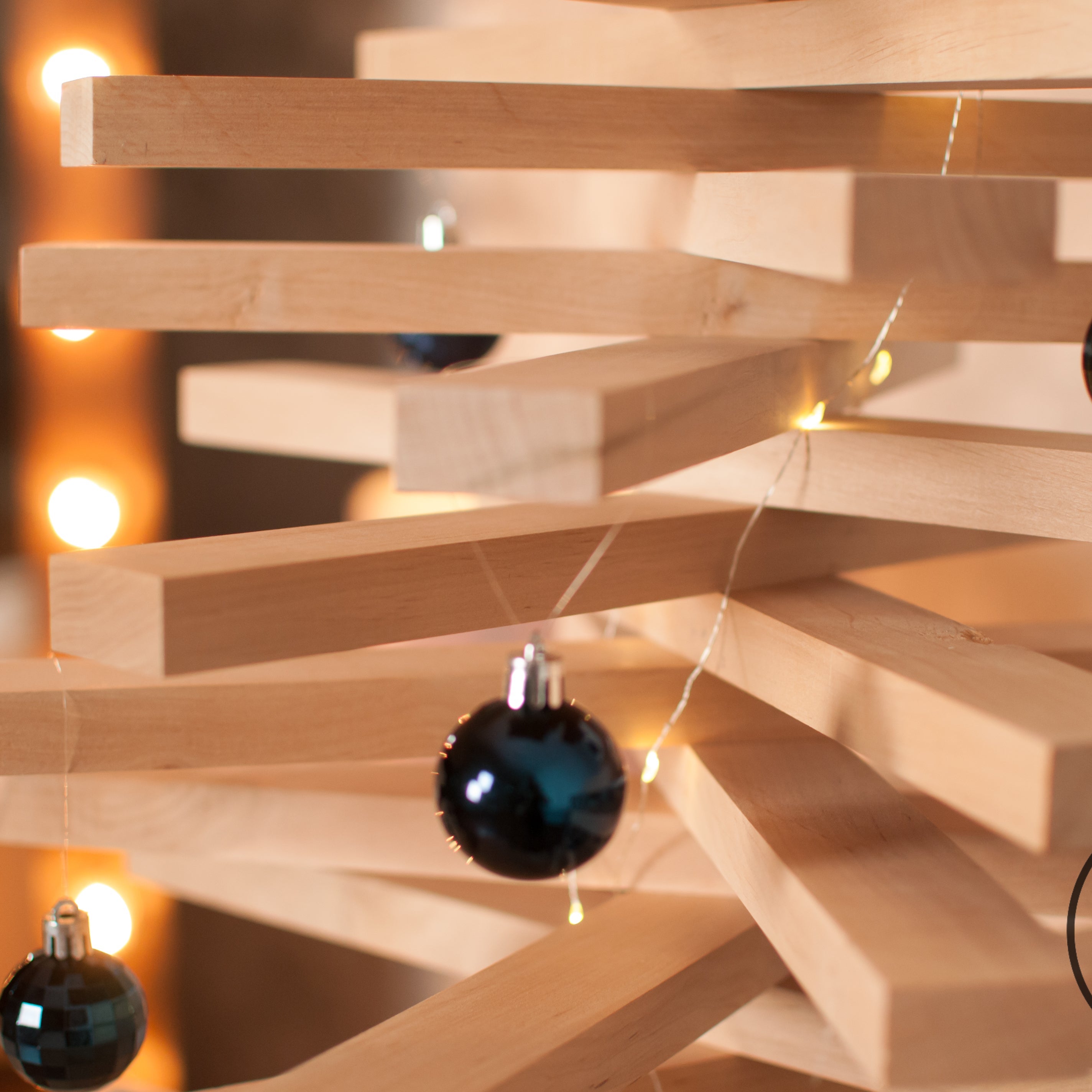 Handmade wooden Christmas tree with rotating branches in modern Scandinavian living room